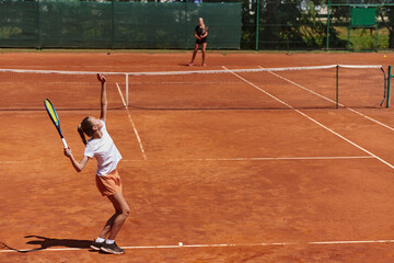 Young girls in a lively tennis match on a sunny day, demonstrating their skills and enthusiasm on a modern tennis court.