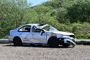 Fototapeta na wymiar car wreck abandoned in gravel lot
