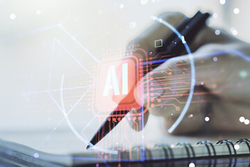 Double exposure of creative artificial Intelligence abbreviation with woman hand writing in notepad on background. Future technology and AI concept