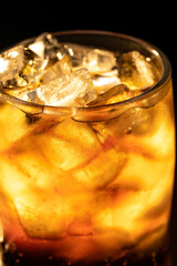 A cold drink in a glass filled with ice