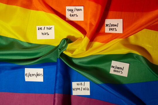 Neo pronouns concept. Rainbow flag with paper notes text gender pronouns hie, e, ne, xe, ze, tey. Non-binary people rights transgenders. Lgbtq community support assume my gender, respect pronouns