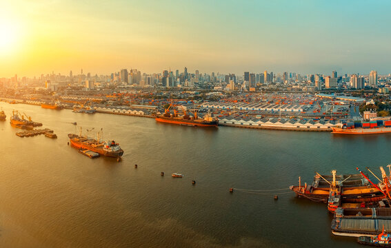high angle view of chaopraya river and shipping dock against city scape of bangkok skyscraper