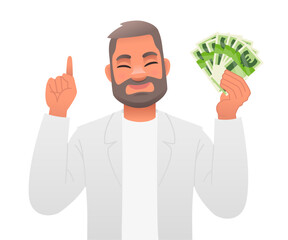 An adult bearded man holds euro banknotes in his hand and points to something with the other. A handsome man in a white suit with money in his hand. A happy businessman.