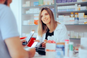 Customer Paying at the Pharmacy using Credit Card Method of Payment. Happy pharmacist assisting a...