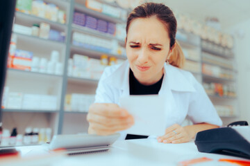 Pharmacist Having Problems Reading Doctor Handwriting on a Prescription. Drugstore worker...