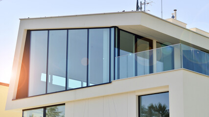 Elegant white house with open concept. Modern luxury villa exterior. A modern house with large windows and glazing.