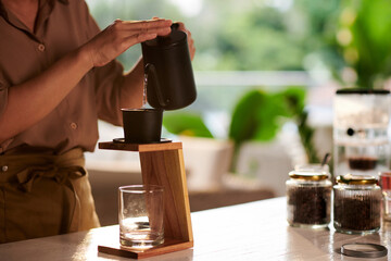 Closeup image of barista making Vietnamese style coffee for customer