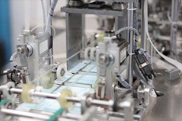 Industry and factory concept, medical face mask production line.