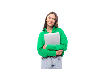 Obraz premium cute young brown-eyed brown-haired careerist woman with makeup in a green blouse works remotely in the IT field