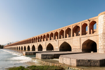Fototapeta na wymiar Si-o-Se Pol (Bridge of 33 Arches or Allahverdi Khan Bridge) on Zayanderud River in Isfahan, Iran. Architectural masterpiece and historical heritage. Tourist attraction.