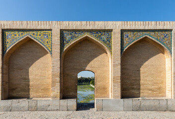 Finely decorated arches on historic Khaju Bridge (Pol-e Khajoo) on Zayanderud River in Isfahan, Iran. Heritage and tourist attraction.