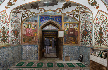 Fototapeta na wymiar Beautiful fresco paintings, tiling, patterns in Mausoleum of Harun-i Vilayat or Imamzadeh Haroun-e-Velayat next to Imam Ali Square in Isfahan, Iran. Historical site and heritage.