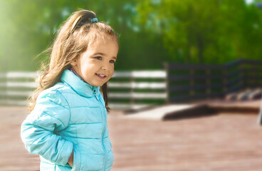 Happy little girl having fun in the park