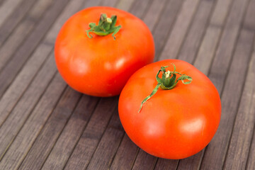 ripe appetizing rispentomatoes tomatoes on wooden table