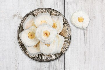 Tasty arabic sweets in plate on the desk
