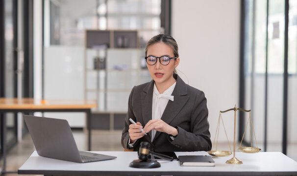 Lawyers Asiawoman   having through online Concepts  of Legal services at the law office.