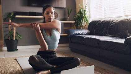 Stretching, Indian woman and laptop for online yoga on living floor for training, balance or...