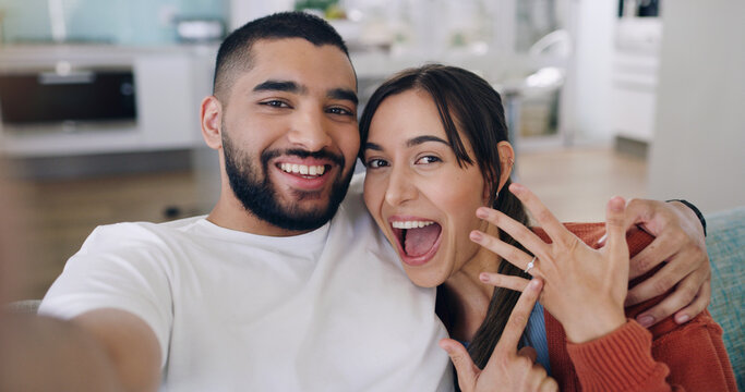 Couple, selfie and engagement ring in home portrait with happiness, romance and love on social media app. Man, woman and profile picture for marriage proposal, offer or celebration with smile on blog