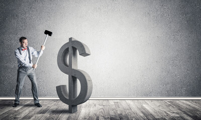 Determined banker man in empty concrete room breaking dollar figure