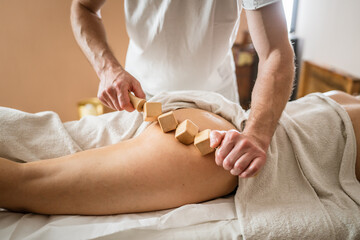 Obraz na płótnie Canvas Caucasian woman having madero therapy massage anti-cellulite treatment