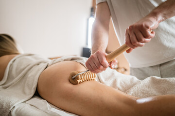 Caucasian woman having madero therapy massage anti-cellulite treatment