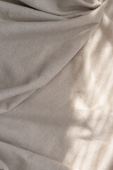 Draped beige linen cloth texture with sunlight shadows, aesthetic bohemian wedding textile...