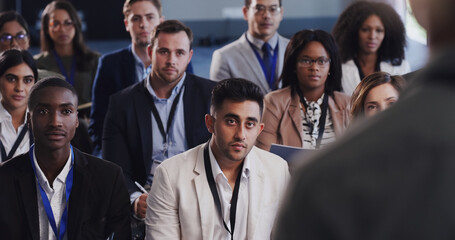 Obraz premium Business people, conference and audience listening to speaker at a seminar, workshop or training. Diversity men and women crowd at a presentation for learning, knowledge and corporate discussion