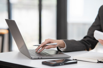 Young Asian businesswoman working on documents at office