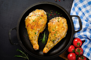 Baked Stuffed Chicken Legs in a Pan on Dark Backround