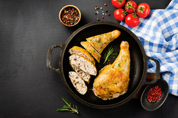 Baked Stuffed Chicken Legs in a Pan on Dark Backround
