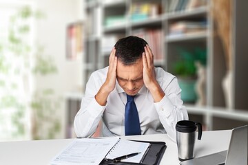 Tired young man at home office