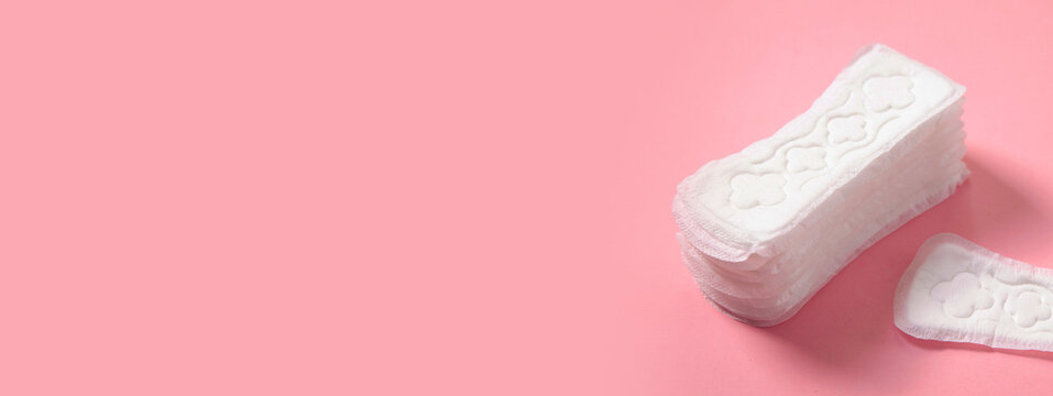 Menstrual pad on a pink background.