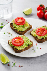 Avocado Toasts with Tomato, Healthy Snack or Breakfast on Bright Background