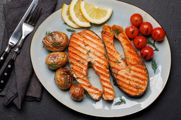 Grilled salmon steaks and potatoes