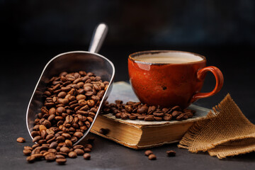 Rich coffee in a cup with aromatic roasted beans