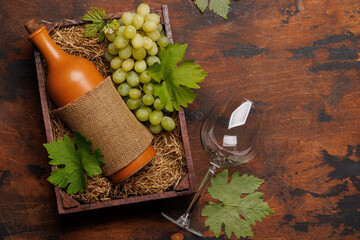 A red wine bottle and fresh grapes