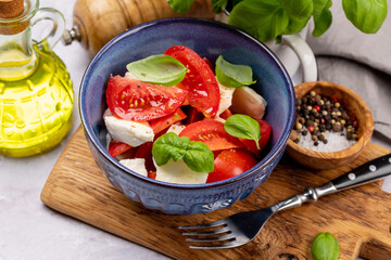 Caprese salad with ripe tomatoes, mozzarella and garden basil