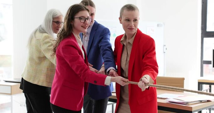 Business people laugh pulling rope in office. Business team and successful unity projects