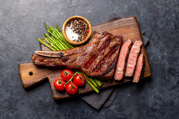 Medium rare grilled Tomahawk beef steak with asparagus