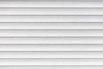 White metal roller shutter door texture background. Texture of white metal roller shutter door