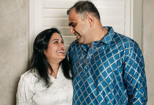 South Asian couple cooking in the Kitchen