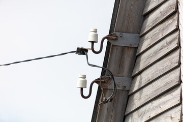 electricity post on the wall of a house, closeup of photo