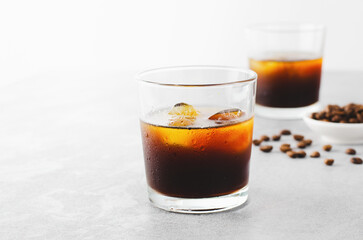 Iced Coffee, Cold Brew Coffee with Ice on Bright Background, Coffee Cocktail, Refreshing Beverage