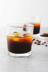 Iced Coffee, Cold Brew Coffee with Ice on Bright Background, Coffee Cocktail, Refreshing Beverage