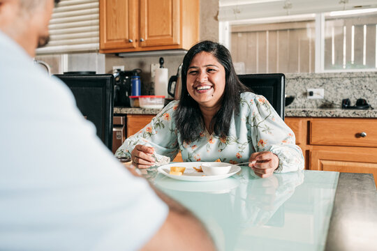South Asian couple eating together