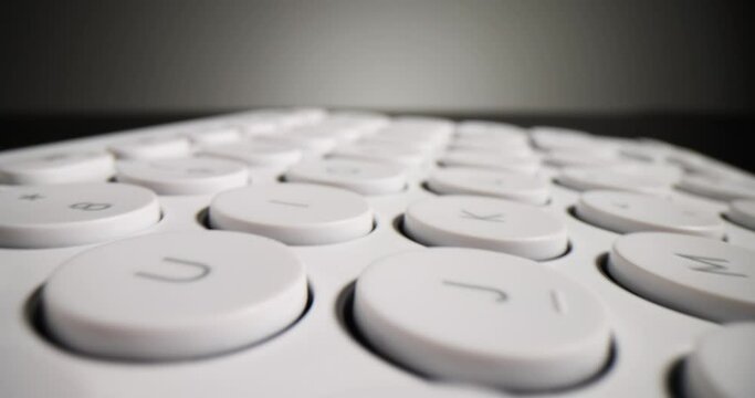 Closeup of white keyboard on black background. Darknet and shadow internet