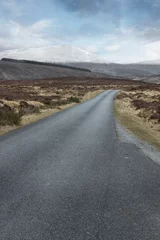 Fototapeten Road at Dalnaspidal Scotland. hills and peat fields. Scottish Highlands. Snow capped mountains. Road trip. © A
