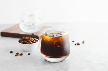 Iced Coffee, Cold Brew Coffee with Ice on Bright Background, Coffee Cocktail, Refreshing Beverage