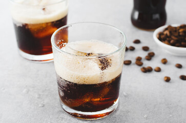 Iced Coffee, Sparkling or Cold Brew Coffee with Ice on Bright Background, Coffee Cocktail, Refreshing Beverage