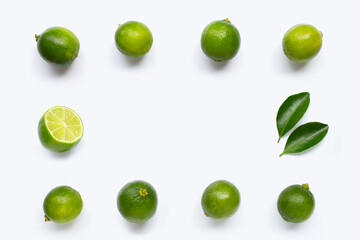 Frame made of fresh limes isolated on white background. Top view